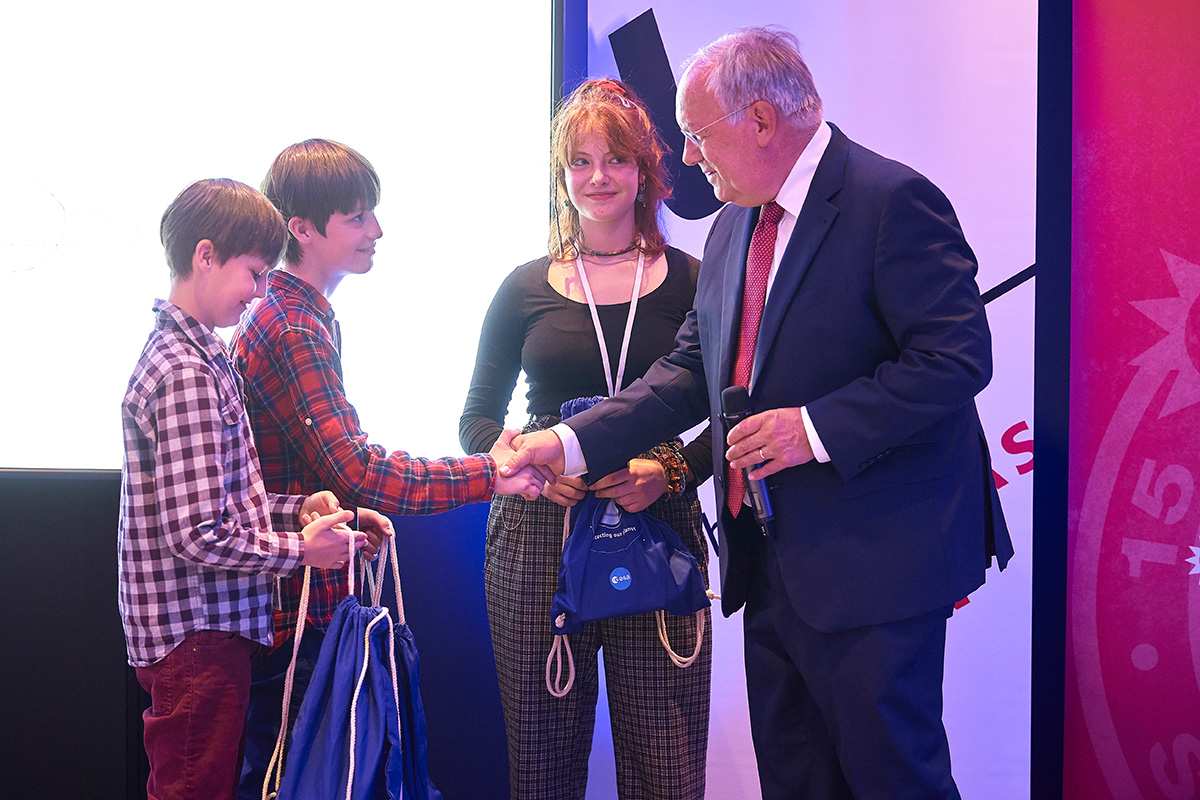 Bundesrat Schneider-Ammann mit den Kindern, die stellvertretend für all diejenigen anwesend waren, deren Zeichnungen mit CHEOPS mitfliegen werden. Bild: Universität Bern / Adrian Moser.