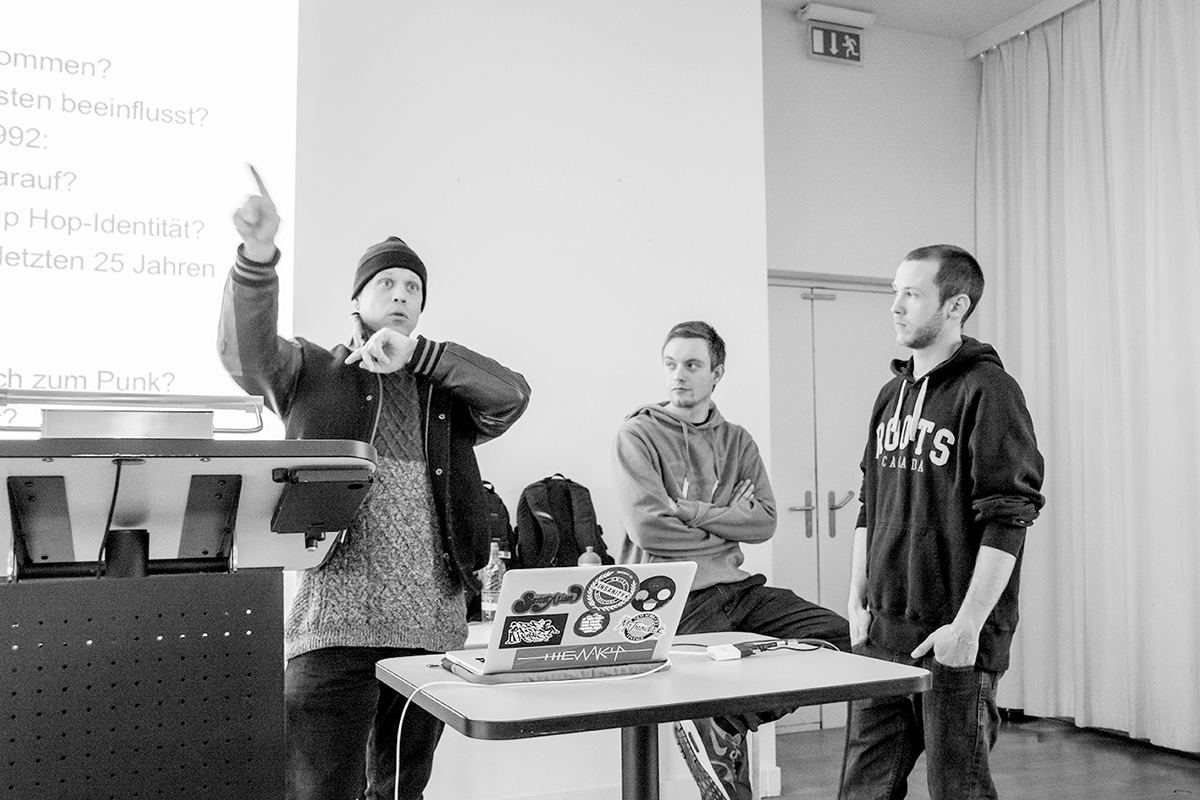 Rapper Black Tiger sowie die Organisatoren Fabrice Wullschleger und Bryan Vit im Vorlesungssaal.