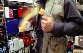 Ein Mann stiehlt Parfüms in einem Laden